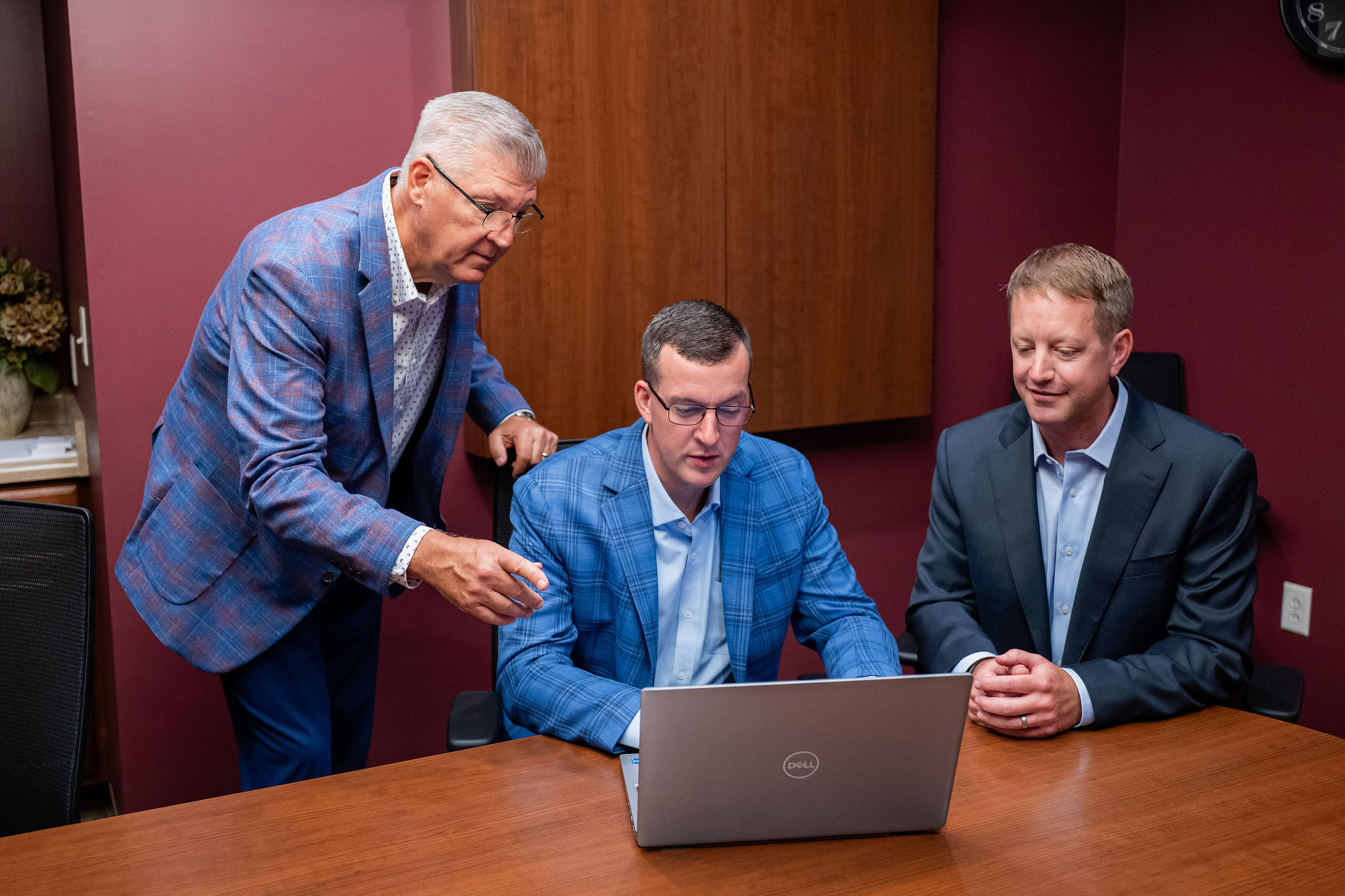 Dostal & Kirk partnership meeting table with branded materials