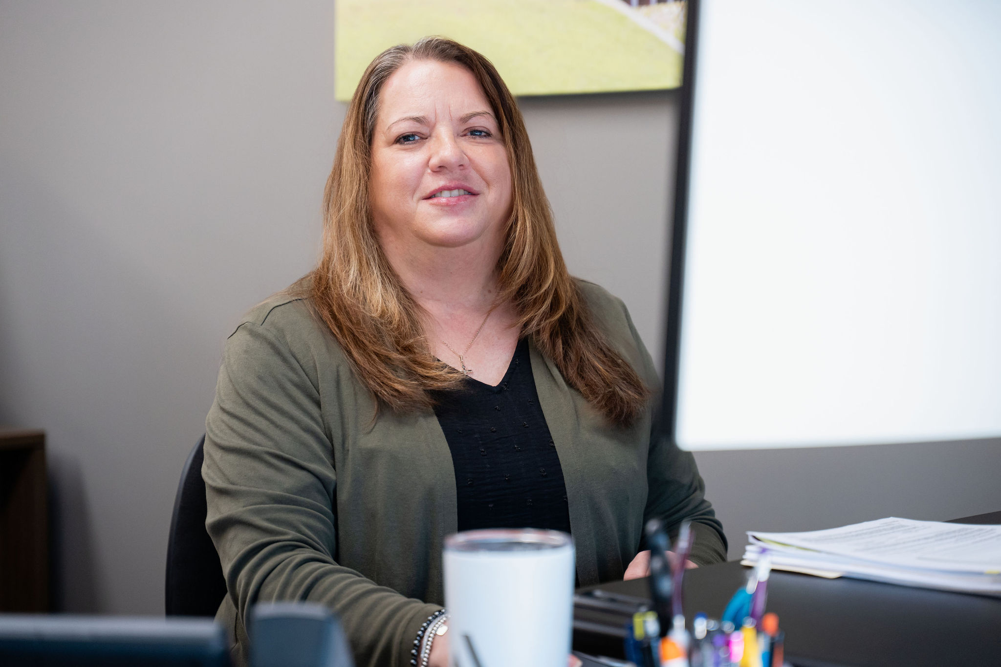 Smiling employee working at her desk