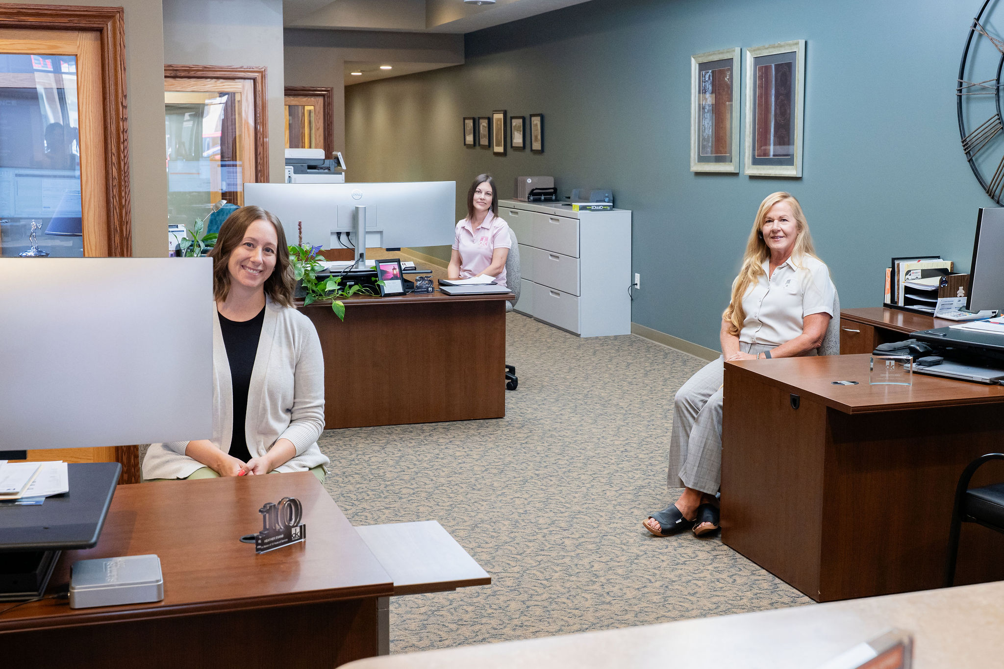 Team members working at their desks in an open office space, creating a welcoming and collaborative atmosphere.
